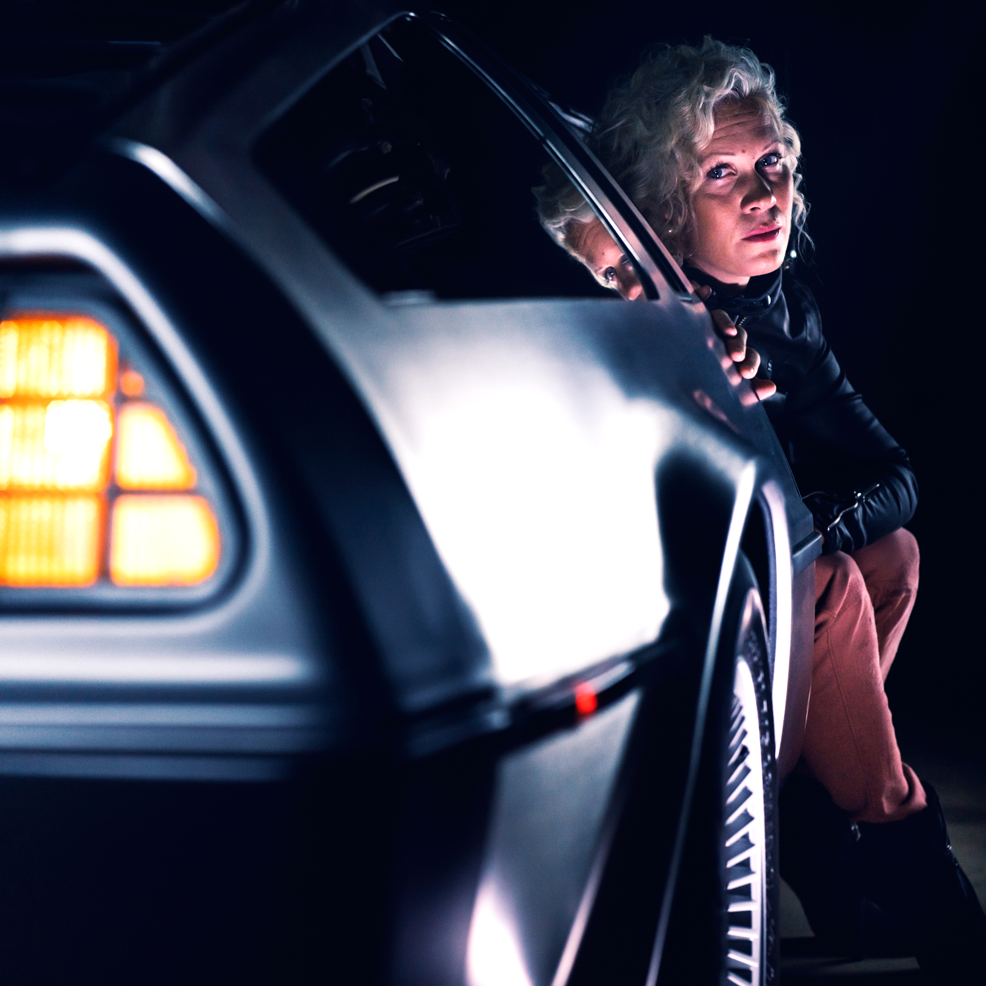 Anna Sköld sitting in a DeLorean